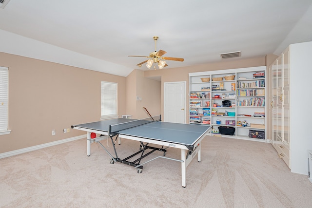 game room with ceiling fan and light colored carpet