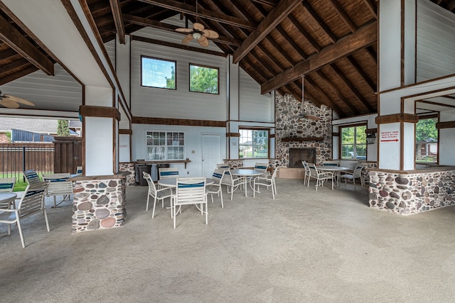 view of patio / terrace with ceiling fan and a fireplace