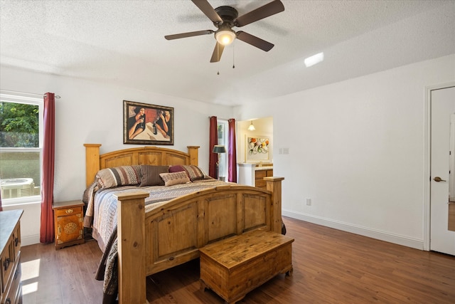 bedroom with a textured ceiling, wood-type flooring, and ceiling fan