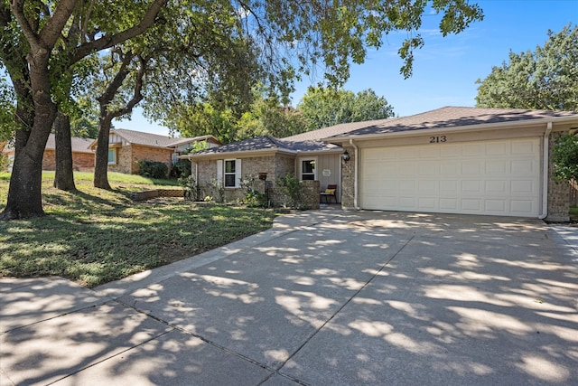 single story home featuring a front lawn and a garage