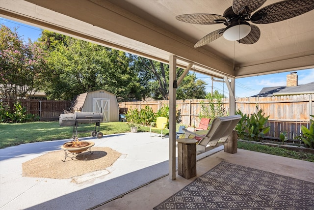 view of patio featuring ceiling fan and a storage shed