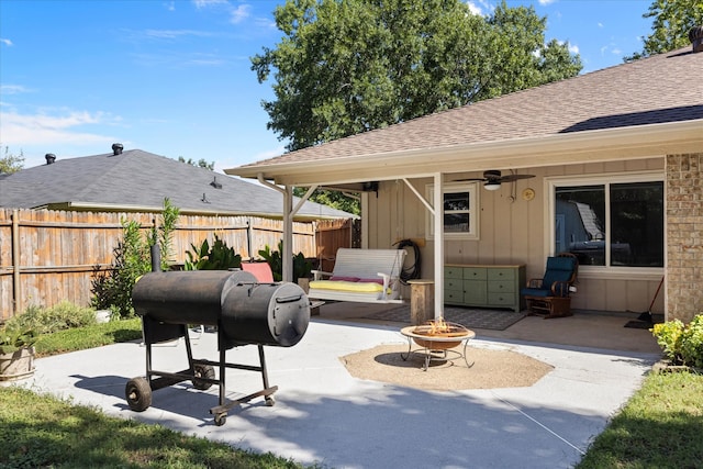 view of patio / terrace featuring area for grilling, ceiling fan, and a fire pit