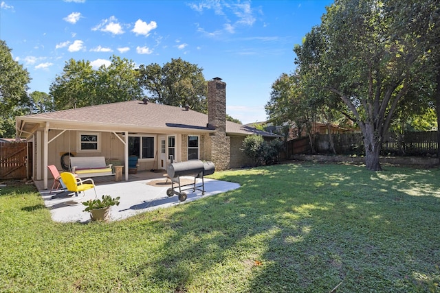 back of property featuring a lawn and a patio