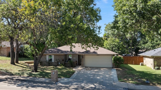 view of front of house featuring a garage and a front lawn