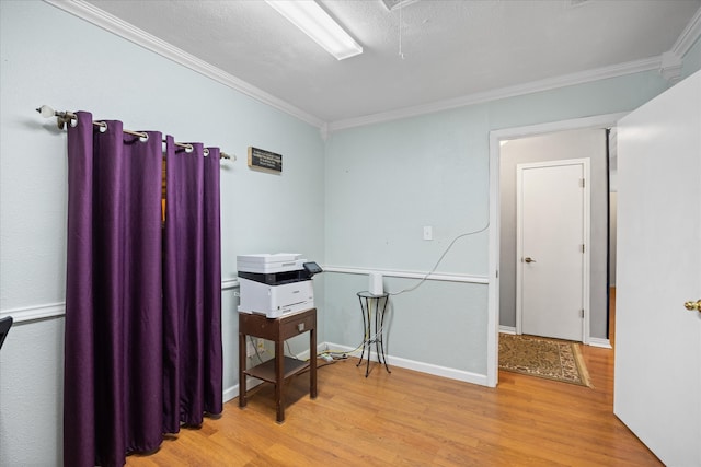 miscellaneous room with light hardwood / wood-style flooring, a textured ceiling, and ornamental molding