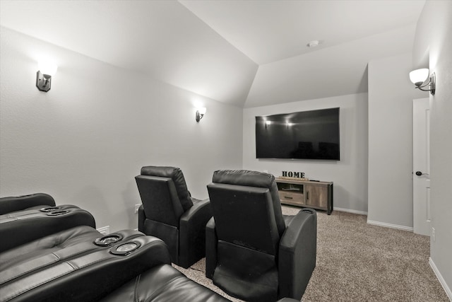 carpeted cinema room featuring vaulted ceiling