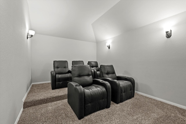 carpeted cinema room with lofted ceiling