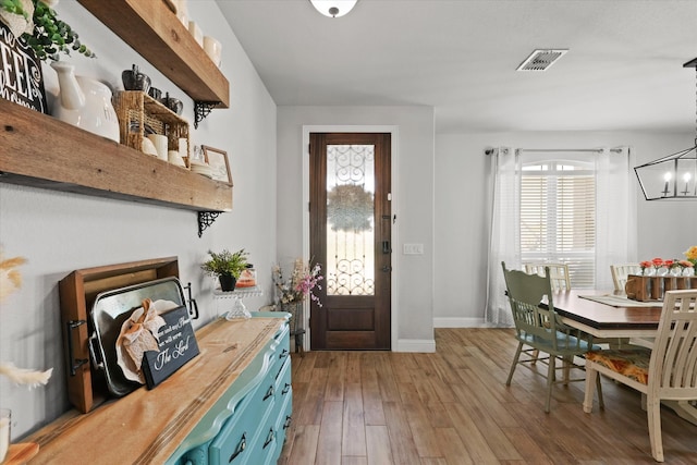 entrance foyer featuring a notable chandelier and hardwood / wood-style flooring