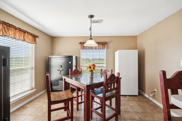 dining room with a healthy amount of sunlight and light tile patterned flooring