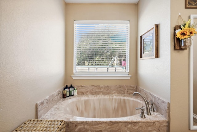 115 Rosser Ranch Rd, Graham, TX 76450 - bathroom featuring a garden tub and a textured wall