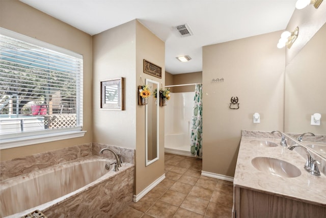 bathroom featuring shower with separate bathtub, vanity, and tile patterned floors