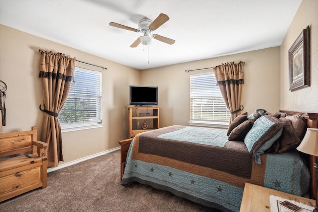 carpeted bedroom featuring multiple windows and ceiling fan