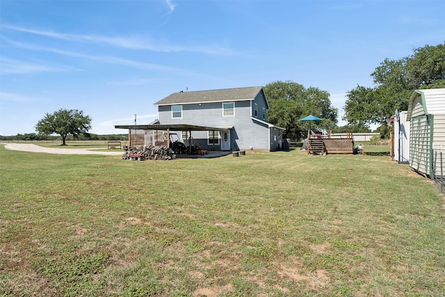 rear view of property with a lawn