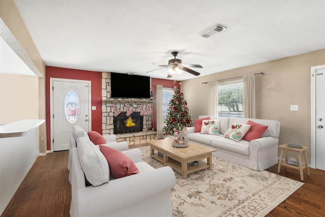 115 Rosser Ranch Rd, Graham, TX 76450 - living room featuring a ceiling fan, wood finished floors, a stone fireplace, and baseboards