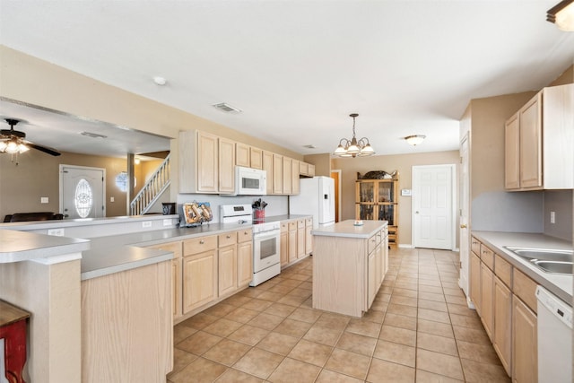 115 Rosser Ranch Rd, Graham, TX 76450 - kitchen with white appliances, light brown cabinetry, a center island, and light tile patterned flooring
