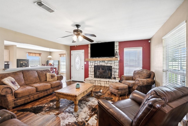 living room featuring a fireplace, ceiling fan, and hardwood / wood-style floors