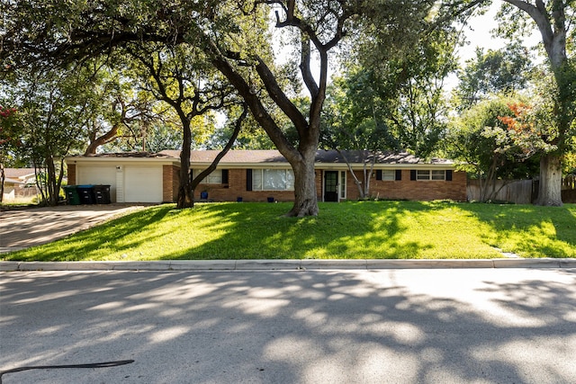 ranch-style house with a garage and a front yard