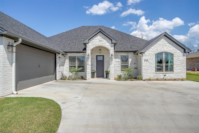 french country inspired facade with a garage and a front yard