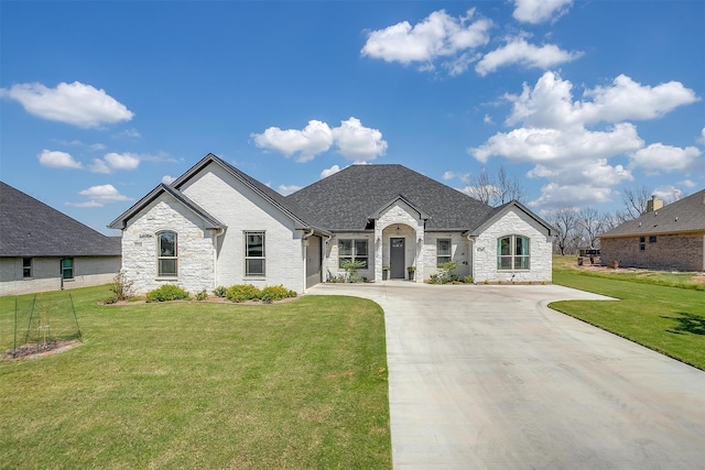 french country inspired facade with a front yard