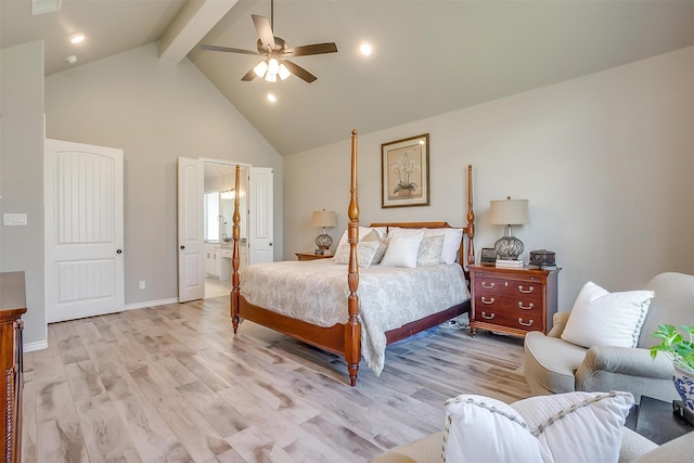 bedroom featuring light wood finished floors, beam ceiling, high vaulted ceiling, ceiling fan, and ensuite bathroom
