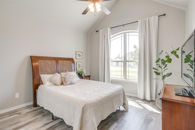 bedroom with light hardwood / wood-style flooring, multiple windows, high vaulted ceiling, and ceiling fan