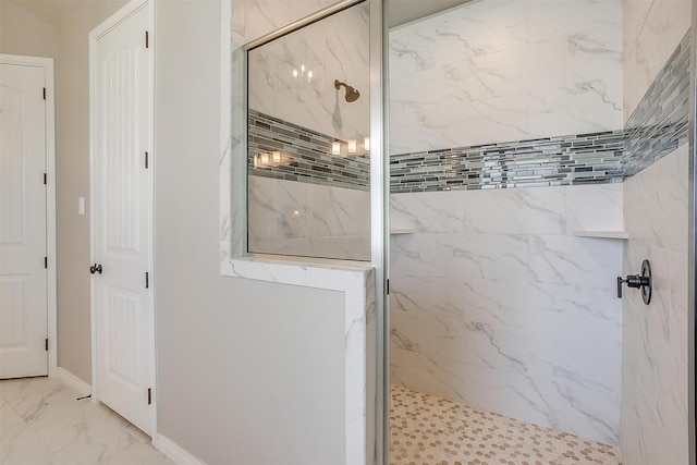 bathroom with baseboards, a marble finish shower, and marble finish floor