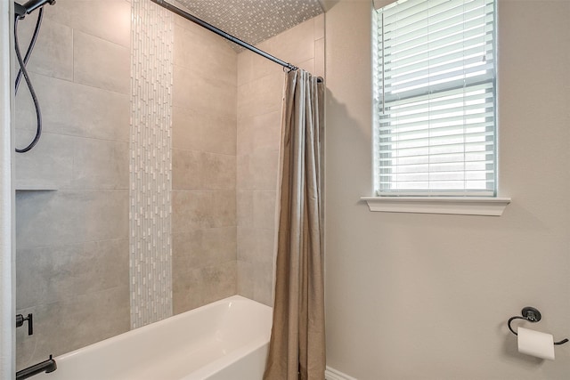 bathroom featuring shower / bathtub combination with curtain and a wealth of natural light