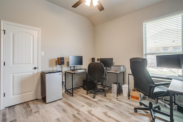 office space featuring lofted ceiling, ceiling fan, and light wood-type flooring