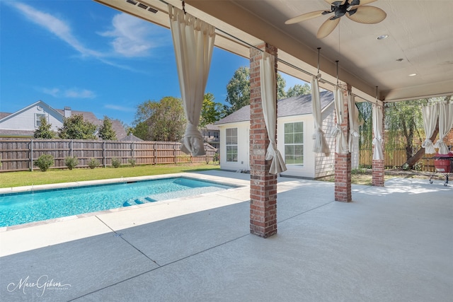 view of swimming pool with ceiling fan and a patio area