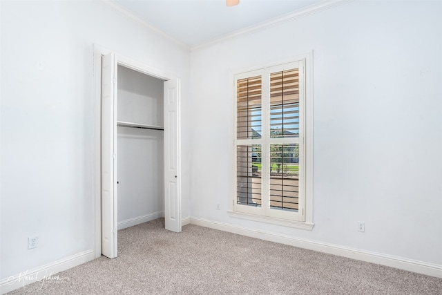 unfurnished bedroom with light carpet, a closet, and ornamental molding