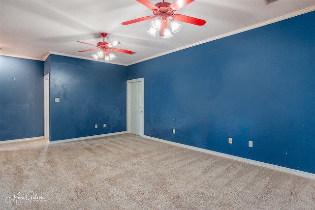 carpeted spare room featuring crown molding and ceiling fan