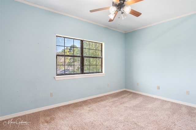 empty room featuring crown molding, carpet flooring, and ceiling fan