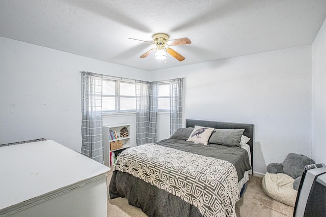 bedroom with carpet, a textured ceiling, and ceiling fan