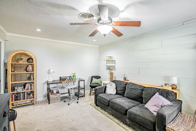 carpeted living room featuring crown molding, ceiling fan, and a textured ceiling