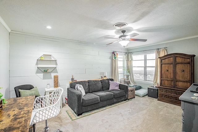 living room with a textured ceiling, crown molding, and light carpet