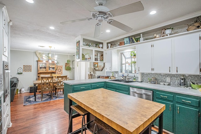 kitchen featuring dishwasher, a center island, white cabinetry, and green cabinets