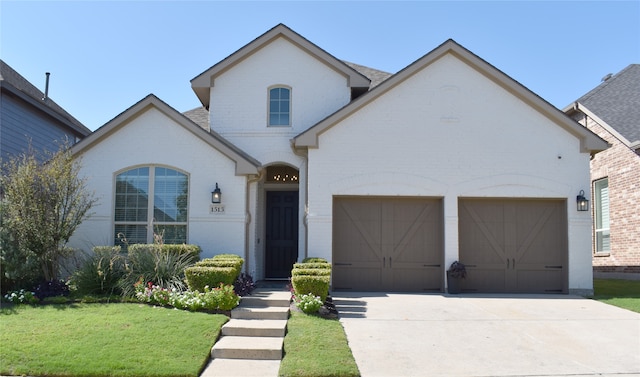 view of front of house featuring a front lawn and a garage