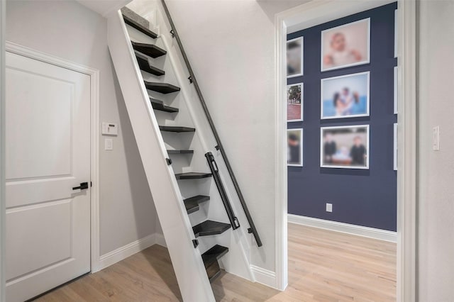 staircase featuring wood-type flooring