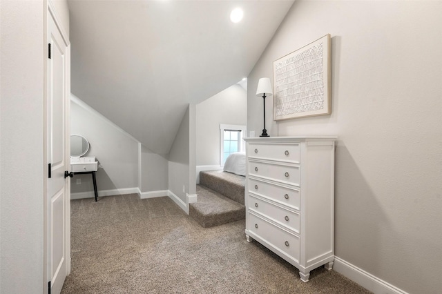 interior space featuring carpet and lofted ceiling