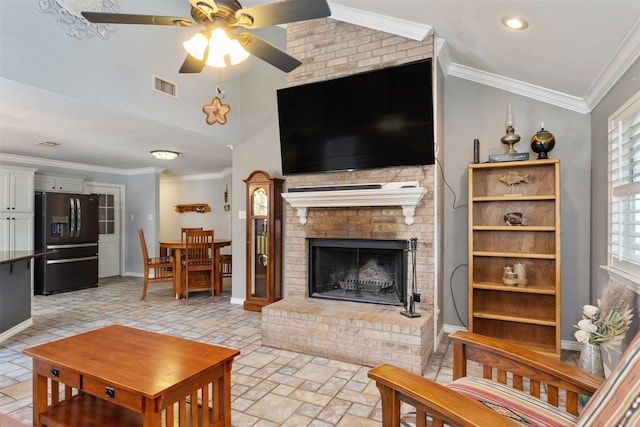 living room with lofted ceiling, a brick fireplace, ornamental molding, and ceiling fan