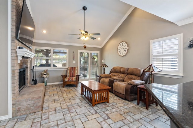 living room featuring lofted ceiling, a fireplace, ceiling fan, and ornamental molding