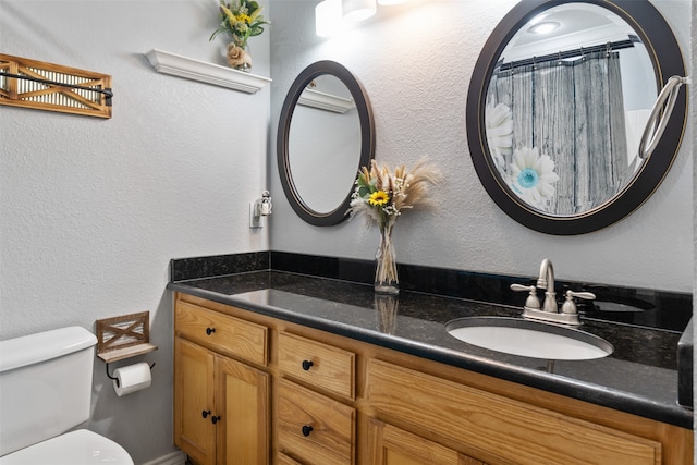 bathroom featuring toilet and vanity