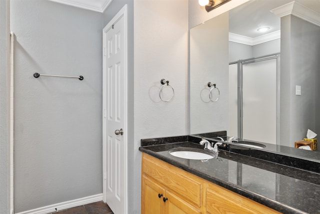 bathroom with walk in shower, tile patterned floors, crown molding, and vanity