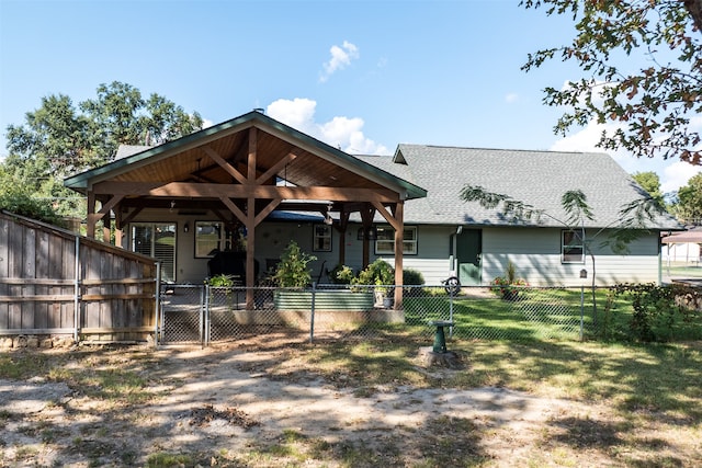 rear view of property with a yard