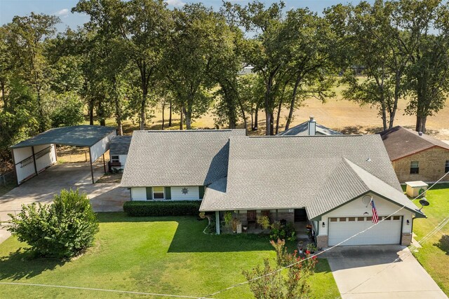 ranch-style house featuring a garage and a front lawn