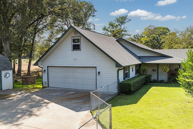 view of front of property featuring a front yard and a garage