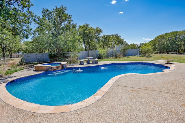 view of swimming pool with pool water feature, an in ground hot tub, and a patio area