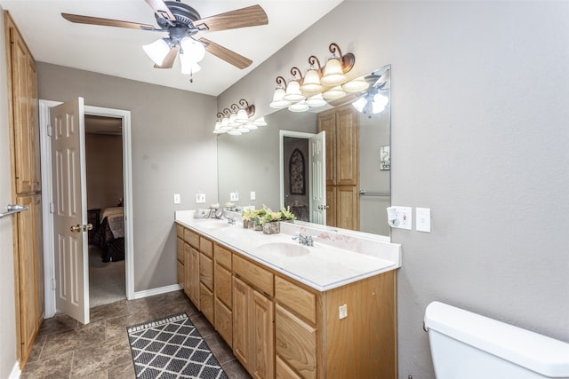 bathroom featuring ceiling fan, vanity, and toilet