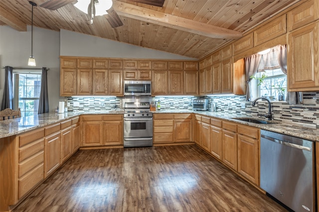 kitchen featuring decorative backsplash, pendant lighting, stainless steel appliances, ceiling fan, and sink