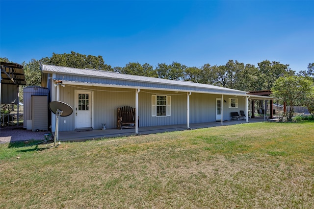 rear view of house with a yard and a patio